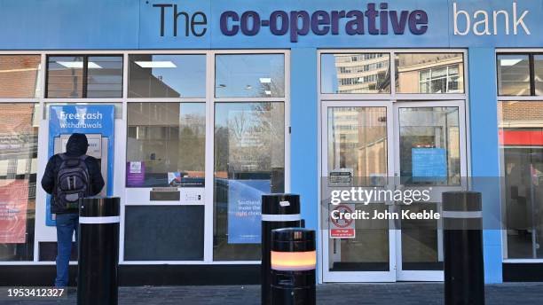 Customer uses a cash machine at a Co-Op, Co-Operative Bank on January 18, 2024 in Southend, United Kingdom.