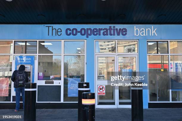 Customer uses a cash machine at a Co-Op, Co-Operative Bank on January 18, 2024 in Southend, United Kingdom.