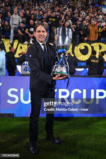 Head Coach Simone Inzaghi of FC Internazionale poses with the trophy at the end of the Italian EA Sports FC Supercup Final match between SSC Napoli...