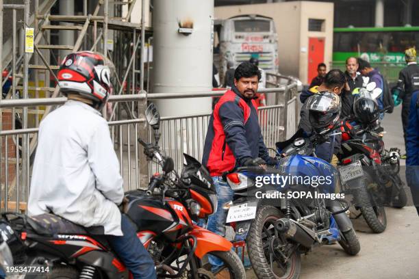 Ridesharing motorbike riders wait for passengers in Dhaka.