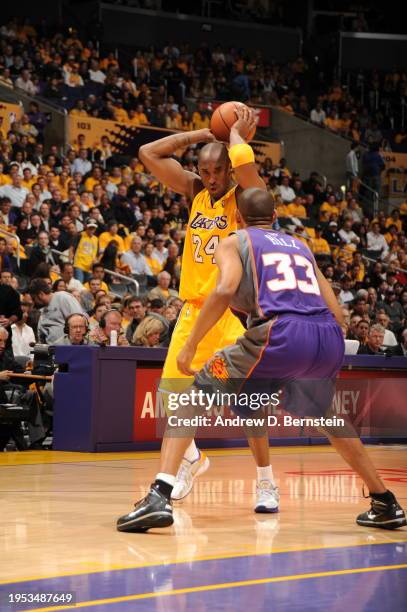 Kobe Bryant of the Los Angeles Lakers looks to drive against Grant Hill of the Phoenix Suns in Game One of the Western Conference Finals during the...