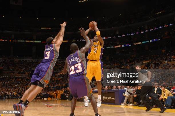 Kobe Bryant of the Los Angeles Lakers shoots against Jared Dudley and Jason Richardson of the Phoenix Suns in Game One of the Western Conference...