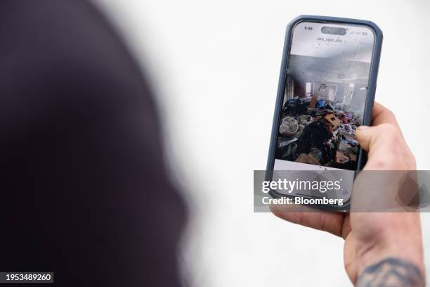 Waste piled up on a property, occupied illegally, on a smartphone of a worker at a cleaning company in Atlanta, Georgia, US, on Friday, Nov. 17,...