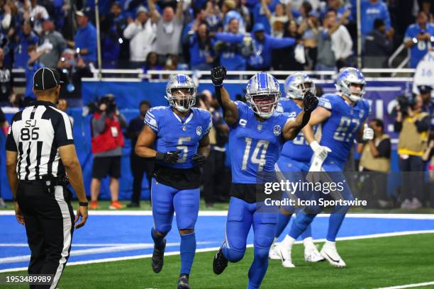 Detroit Lions wide receiver Amon-Ra St. Brown celebrates as he runs off of the field after catching a touchdown pass in the corner of the end zone...