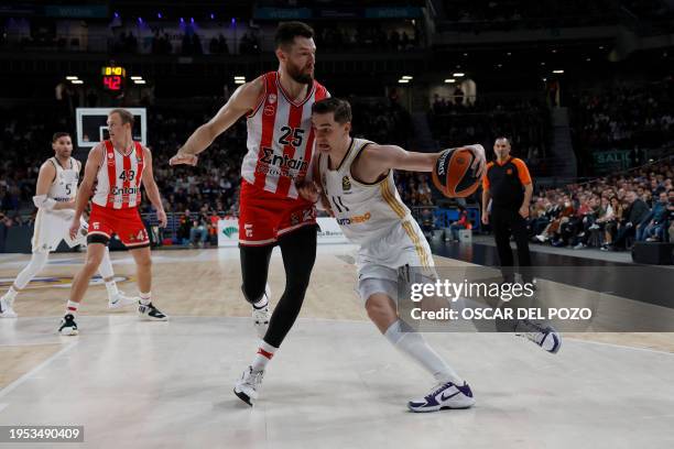 Real Madrid's Croatian forward Mario Hezonja vies with Olympiacos Piraeus' US forward Alec Peters during the Euroleague round 23 basketball match...