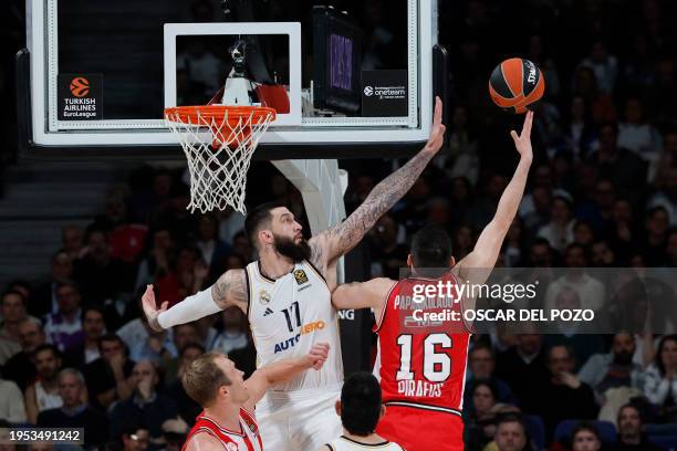 Real Madrid's French center Vincent Poirier defends againts Olympiacos Piraeus' Greek forward Kostas Papanikolaou during the Euroleague round 23...