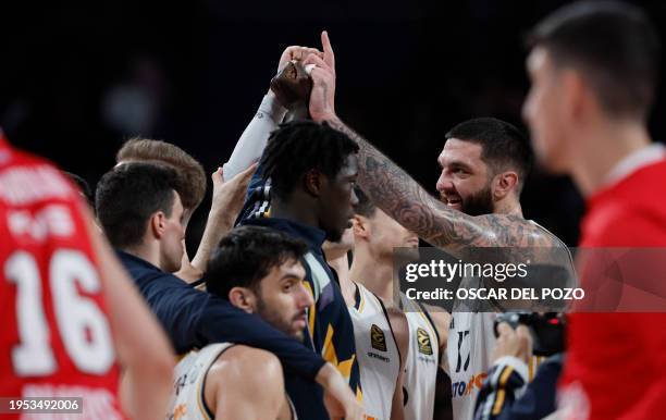 Real Madrid's French center Vincent Poirier and teammates celebrate victory at the end of the Euroleague round 23 basketball match between Real...