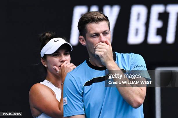 Britain's Neal Skupski and partner Desirae Krawczyk of the US discuss tactics during their mixed doubles final match against Poland's Jan Zielinski...