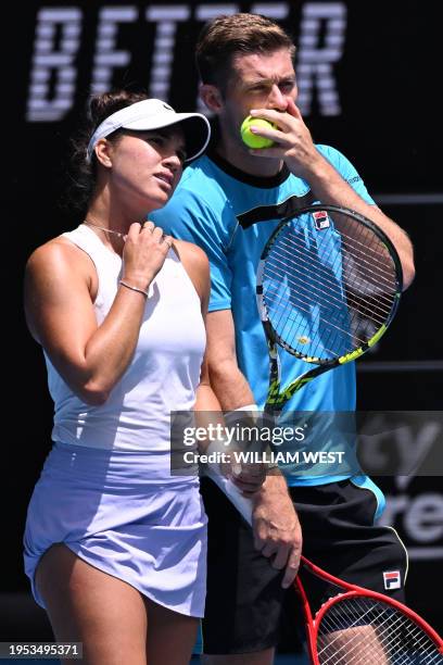 Britain's Neal Skupski and partner Desirae Krawczyk of the US discuss tactics during their mixed doubles final match against Poland's Jan Zielinski...