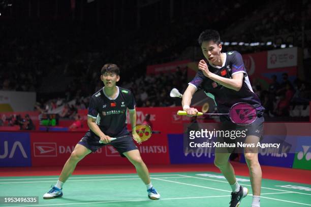 China's Liu Yuchen/Ou XuanyiR compete during the men's doubles first round match between Denmark's Rasmus Kjaer/Frederik Sogaard and China's Liu...