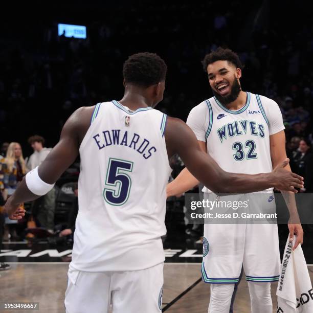 Karl-Anthony Towns high fives Anthony Edwards of the Minnesota Timberwolves after the game against the Brooklyn Nets on January 25, 2024 at Barclays...