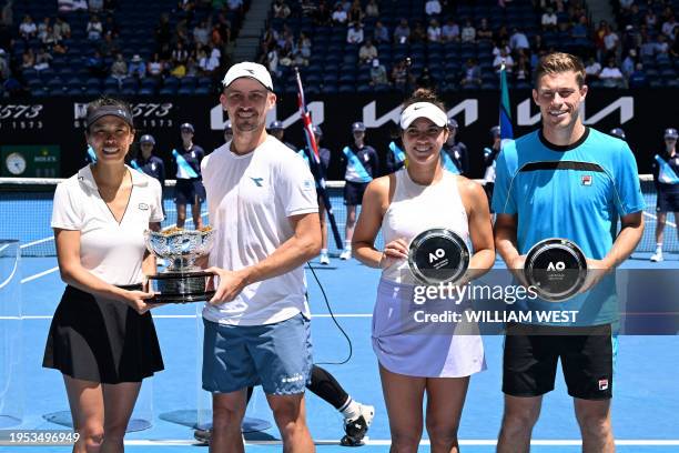 Taiwan's Su-wei Hsieh and her partner Jan Zielinski of Poland celebrate with the winners' trophy as Britain's Neal Skupski and partner Desirae...