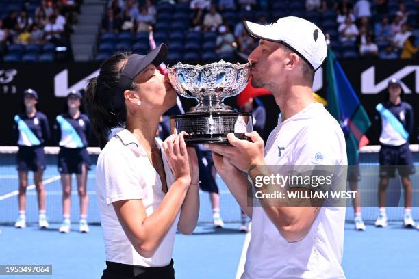 Taiwan's Su-wei Hsieh and her partner Jan Zielinski of Poland celebrate with the trophy following their victory against Britain's Neal Skupski and...