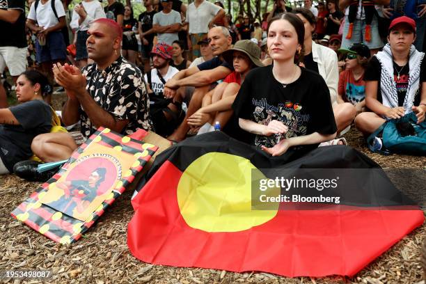 Demonstrator with an Australian Aboriginal flag during an "Invasion Day" rally on Australia Day in Sydney, Australia, on Friday, Jan. 26, 2024....