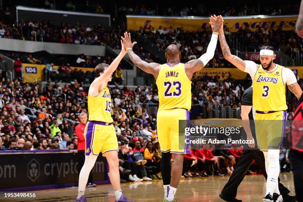 LeBron James of the Los Angeles Lakers high fives Austin Reaves and Anthony Davis during the game against the Chicago Bulls on January 25, 2024 at...