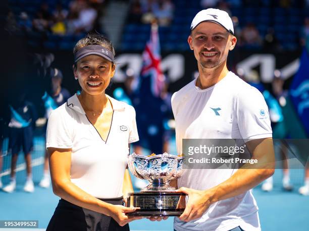 Su-Wei Hsieh of Chinese Taipeh and Jan Zielinski of Poland pose with their champions trophy after defeating Desirae Krawczyk of the United States and...