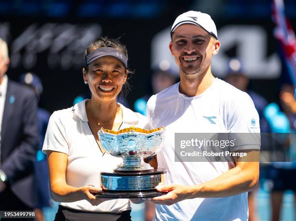 Su-Wei Hsieh of Chinese Taipeh and Jan Zielinski of Poland pose with their champions trophy after defeating Desirae Krawczyk of the United States and...