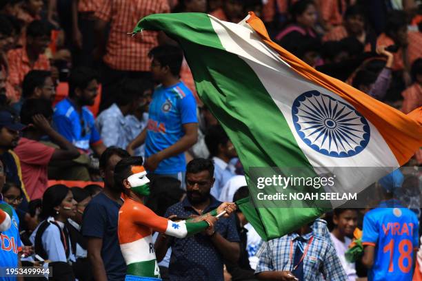 Cricket fan waves India's national flag during second day of the first Test cricket match between India and England at the Rajiv Gandhi International...