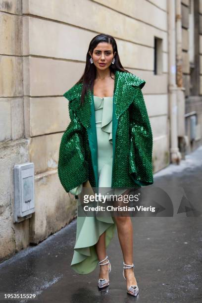 Guest wears green sequined jacket, asymmetric dress outside Georges Hobeika during the Haute Couture Spring/Summer 2024 as part of Paris Fashion Week...