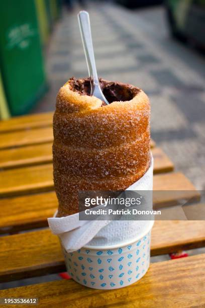 trdelník filled with chocolate spread in prague, czechia - prague food stock pictures, royalty-free photos & images