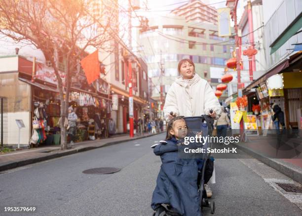 mother and her little daughter visiting china town - kanagawa prefecture stock pictures, royalty-free photos & images
