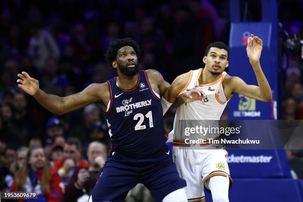 Joel Embiid of the Philadelphia 76ers and Victor Wembanyama of the San Antonio Spurs jostle during the first quarter at the Wells Fargo Center on...