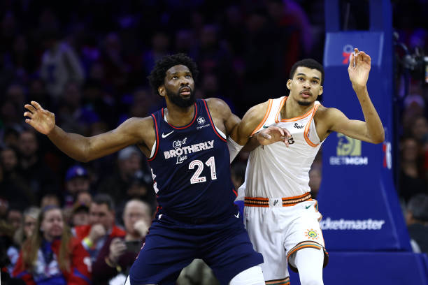 Joel Embiid of the Philadelphia 76ers and Victor Wembanyama of the San Antonio Spurs jostle during the first quarter at the Wells Fargo Center on...