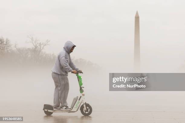 The Washington Monument is emerging through a dense layer of fog from melting evaporated ice on the National Mall in Washington, D.C., on January 25,...