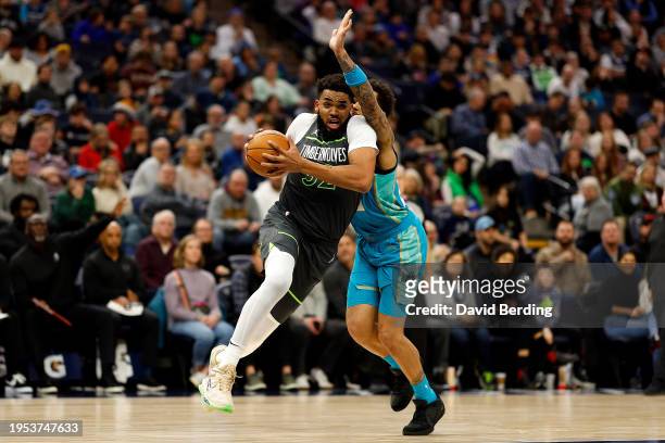 Karl-Anthony Towns of the Minnesota Timberwolves drives against P.J. Washington of the Charlotte Hornets in the second quarter at Target Center on...