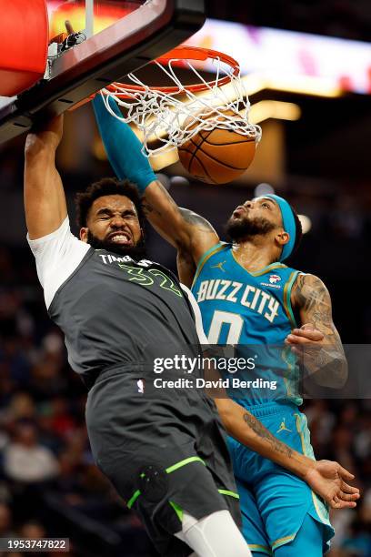 Karl-Anthony Towns of the Minnesota Timberwolves dunks the ball against Miles Bridges of the Charlotte Hornets in the second quarter at Target Center...