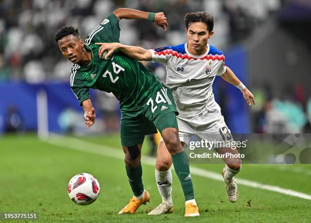 Nasser Al Dawsari of Saudi Arabia is battling for the ball with J. Wonggorn of Thailand during the AFC Asian Cup 2023 match between Saudi Arabia and...