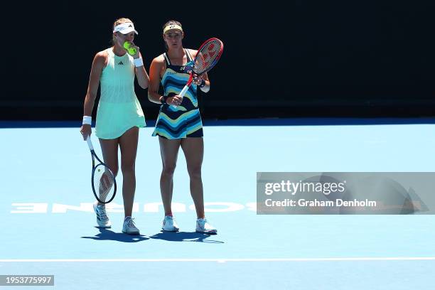 Kristina Mladenovic and Caroline Garcia of France talk tactics in their quarterfinals doubles match against Lyudmyla Kichenok of Ukraine and Jelena...