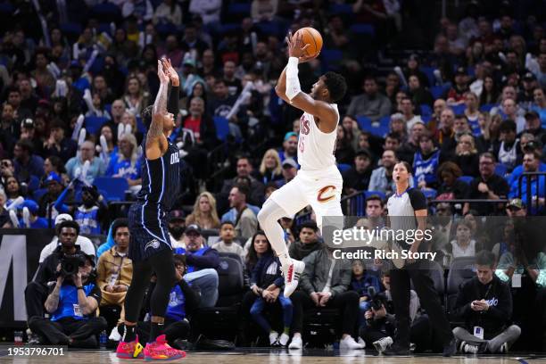 Donovan Mitchell of the Cleveland Cavaliers goes up for a shot over Chuma Okeke of the Orlando Magic during the third quarter at Kia Center on...