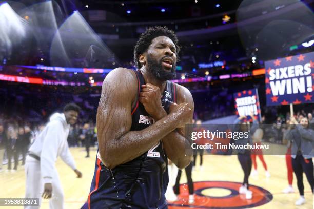 Joel Embiid of the Philadelphia 76ers reacts after being showered with water after defeating the San Antonio Spurs at the Wells Fargo Center on...