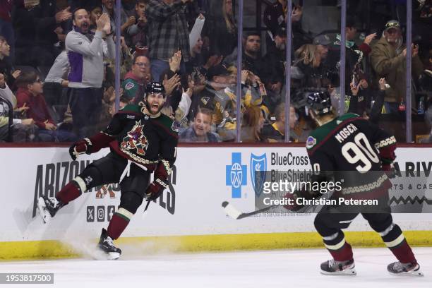 Jason Zucker of the Arizona Coyotes celebrates with J.J. Moser after scoring a goal against the Pittsburgh Penguins during the first period of the...