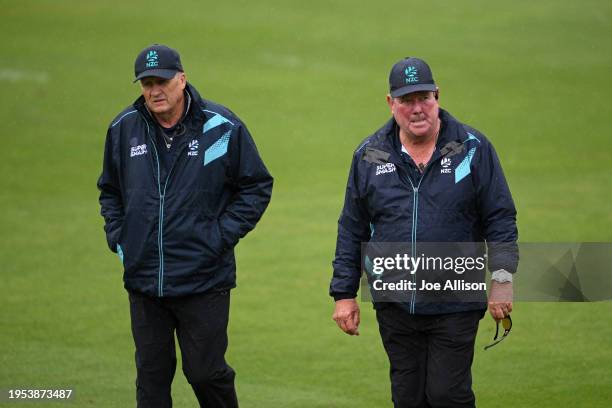 Umpires Tim Parlane and Derek Walker walk off the field as rain delays play during the T20 Super Smash match between Otago Volts and Northern...