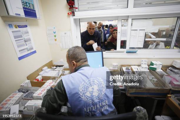 Palestinian patients gather at the UNRWA health center to receive medicines as the Israeli attacks continue in Deir Al-Balah, Gaza on January 21,...