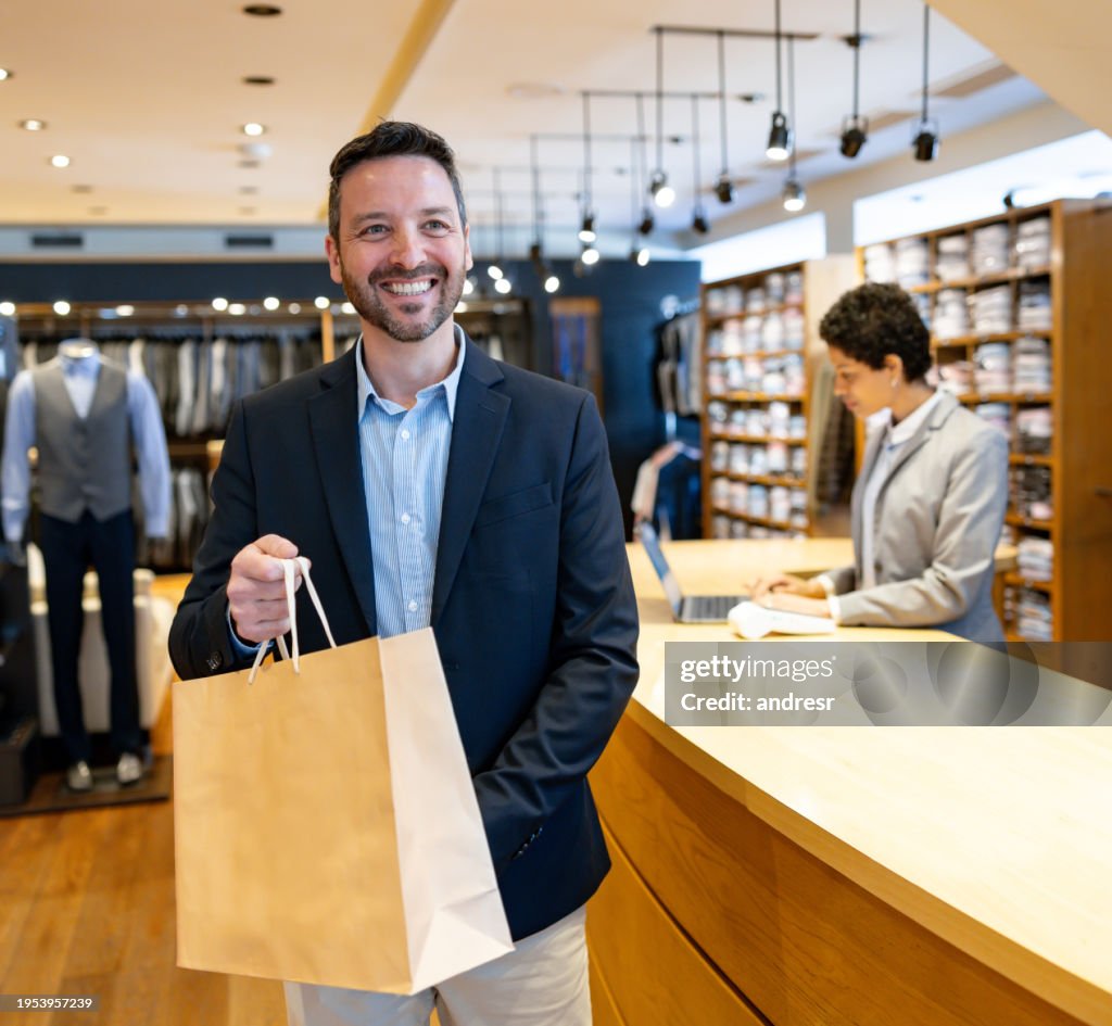 Happy man shopping at a clothing store