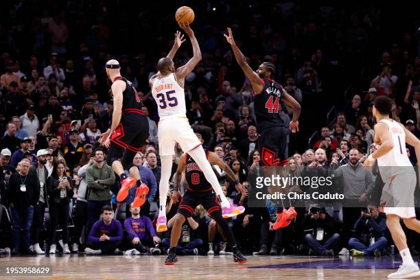 Kevin Durant of the Phoenix Suns hits the go ahead three pointer over Patrick Williams of the Chicago Bulls and Alex Caruso during the second half at...