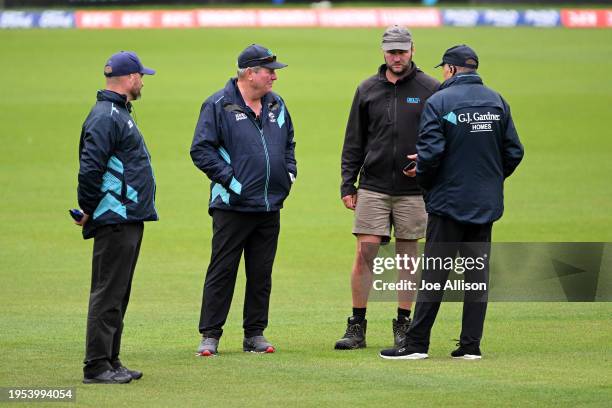 Match officials and a groundsmen discuss playing conditions during the T20 Super Smash match between Otago Volts and Northern Districts Brave at...