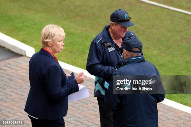 Match officials discuss conditions during the T20 Super Smash match between Otago Volts and Northern Districts Brave at University of Otago Oval on...