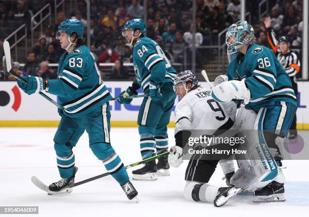 Adrian Kempe of the Los Angeles Kings reacts to a penalty between Kaapo Kahkonen, Jan Rutta and Nikita Okhotiuk of the San Jose Sharks during the...