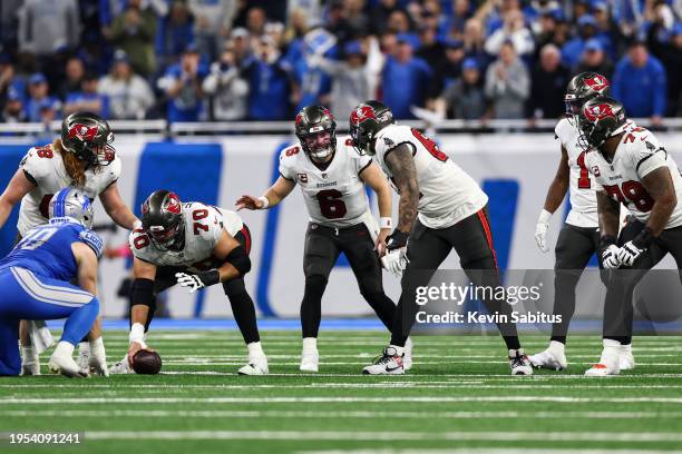 Baker Mayfield of the Tampa Bay Buccaneers communicates to Aaron Stinnie before a play during an NFL divisional round playoff football game against...