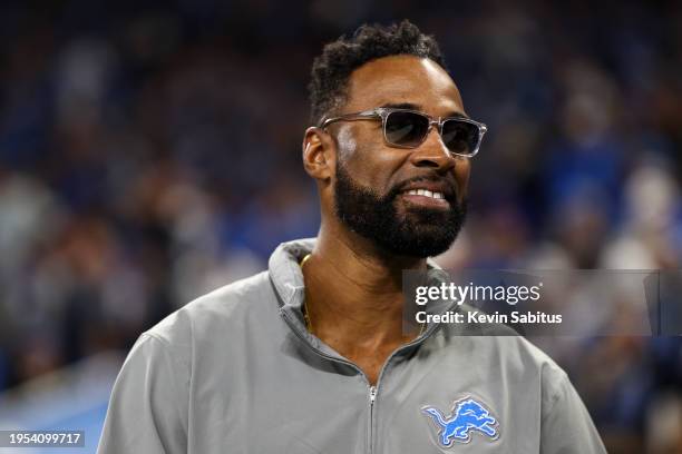 Former wide receiver Calvin Johnson smiles on the field prior to an NFL divisional round playoff football game between the Detroit Lions and the...