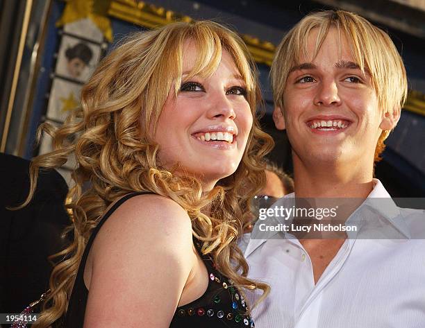 Actress Hilary Duff hugs singer Aaron Carter as they attend the premiere of The Lizzie McGuire Movie on April 26, 2003 in Hollywood, California.