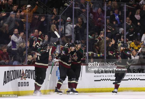 Nick Bjugstad of the Arizona Coyotes celebrates with Juuso Valimaki, Jack McBain and Liam O'Brien after Bjugstad scored a goal against the Pittsburgh...