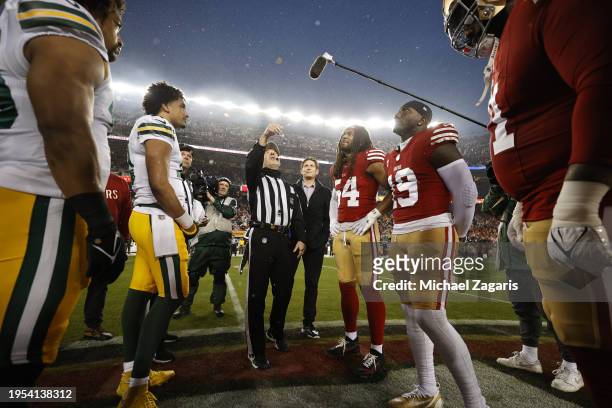 Captains of the San Francisco 49ers and the Green Bay Packers during the coin toss before the NFC Divisional Playoffs game at Levi's Stadium on...
