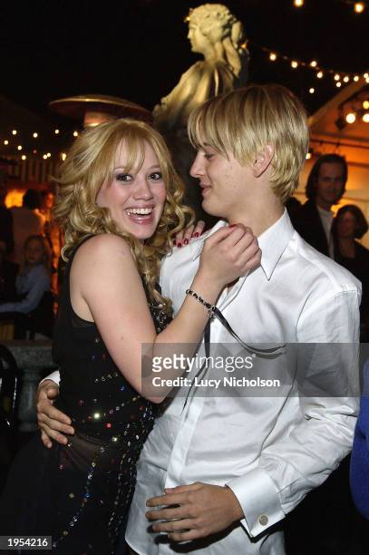 Actress Hilary Duff hugs singer Aaron Carter at the post-premiere party for The Lizzie McGuire Movie on April 26, 2003 in Hollywood, California.
