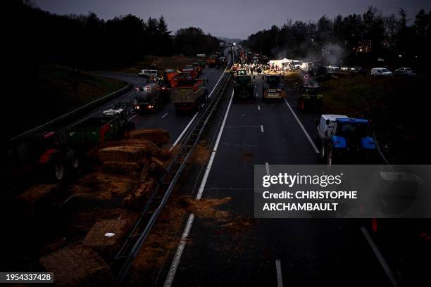 Farmers of the CR47 union gather at dawn as they block the A62 highway near Agen, southwestern France, on January 26, 2024. As they await French...