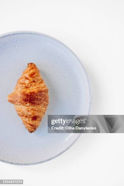 close up fresh delicious croissant on the plate on white table - breaking croissant stock pictures, royalty-free photos & images